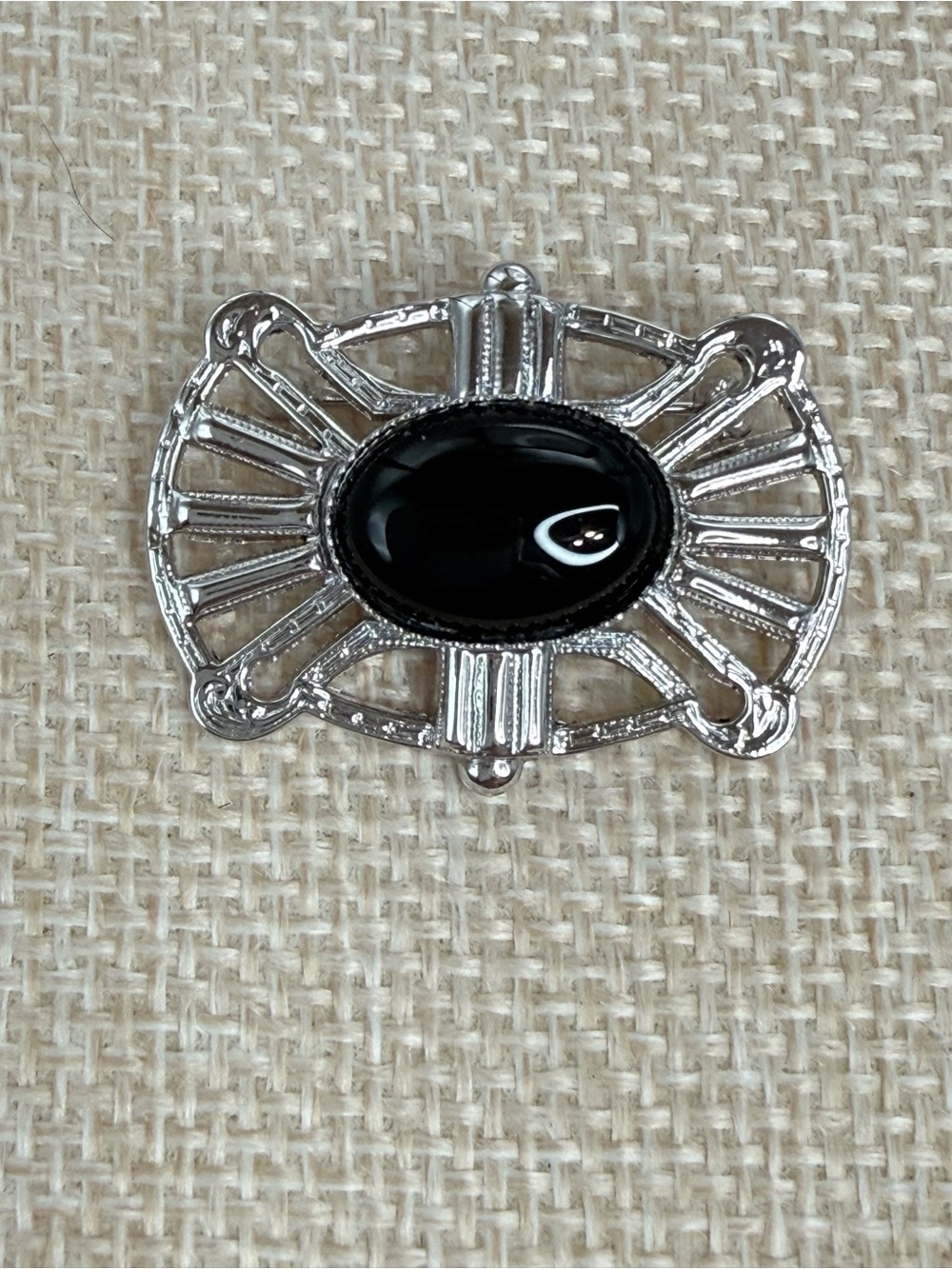 Art Deco Sterling silver brooch oval black onyx stone set in an openwork frame.